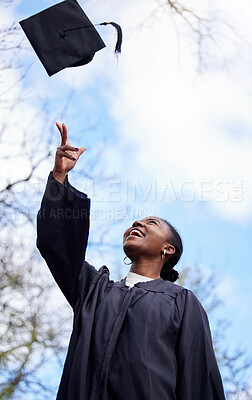 Buy stock photo Shot of a young woman throwing her hat in the air on graduation day
