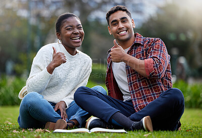 Buy stock photo Shot of a young man and woman showing thumbs up on a study break at college
