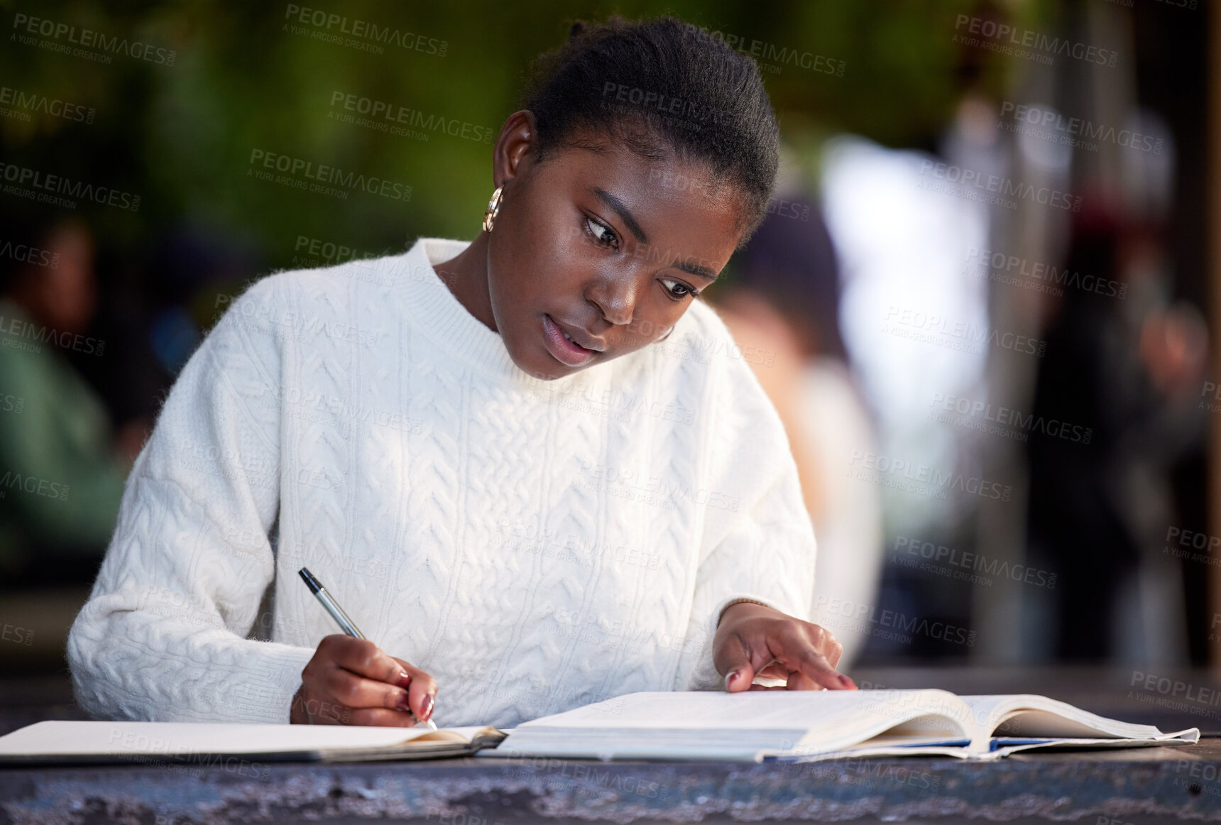 Buy stock photo Shot of a young woman studying in a cafe