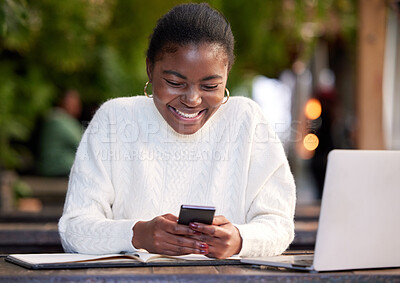 Buy stock photo Shot of a young woman using a smartphone while studying in a cafe