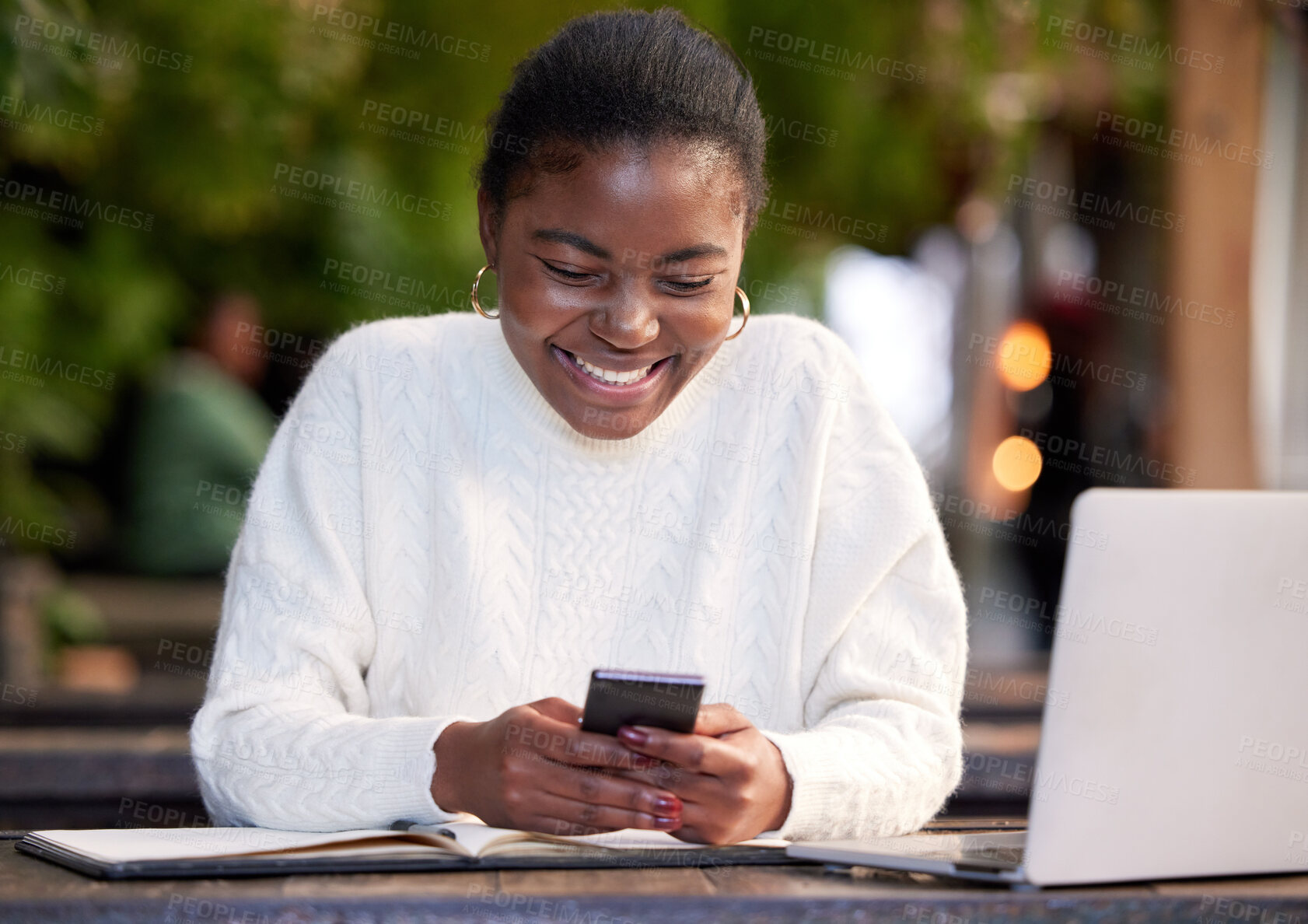 Buy stock photo Shot of a young woman using a smartphone while studying in a cafe