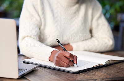 Buy stock photo Shot of an unrecognisable woman studying in a cafe