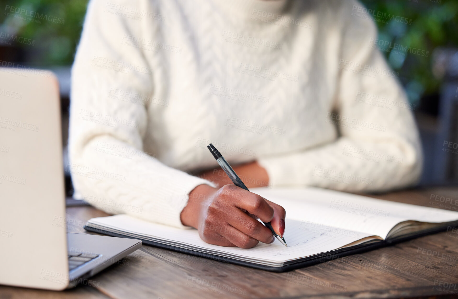 Buy stock photo Shot of an unrecognisable woman studying in a cafe