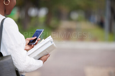 Buy stock photo Shot of a woman using a smartphone outside at college