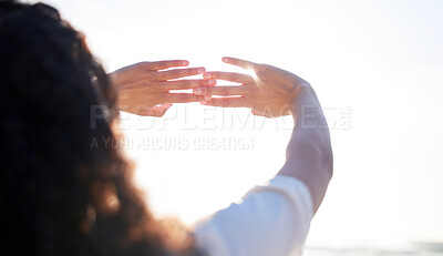 Buy stock photo Shot of an unrecognizable person making a gesture with their hands at the beach