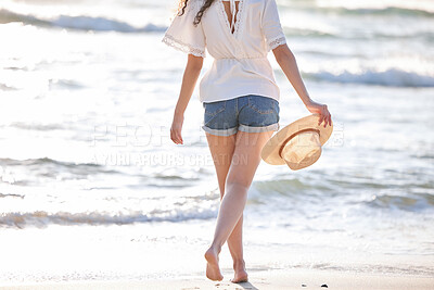 Buy stock photo Shot of an unrecognizable woman enjoying a day at the beach