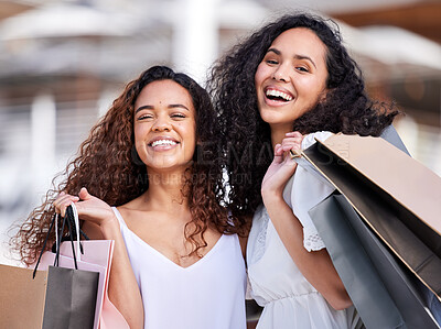 Buy stock photo Shot of two young women shopping against an urban background