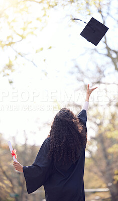 Buy stock photo Rearview shot of a young woman throwing her cap in the air on graduation day
