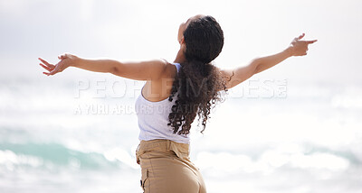 Buy stock photo Shot of a young woman spending a day at the beach