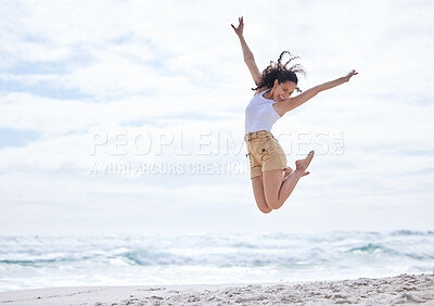 Buy stock photo Shot of a young woman spending a day at the beach