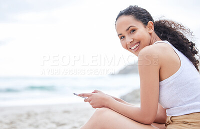 Buy stock photo Woman, portrait and smile on beach with phone for social media scroll, internet browsing or audiobook for relax. Person, happy and smartphone on sand by seaside for holiday, summer vacation or mockup