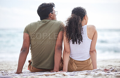 Buy stock photo Shot of a young couple taking a break at the beach