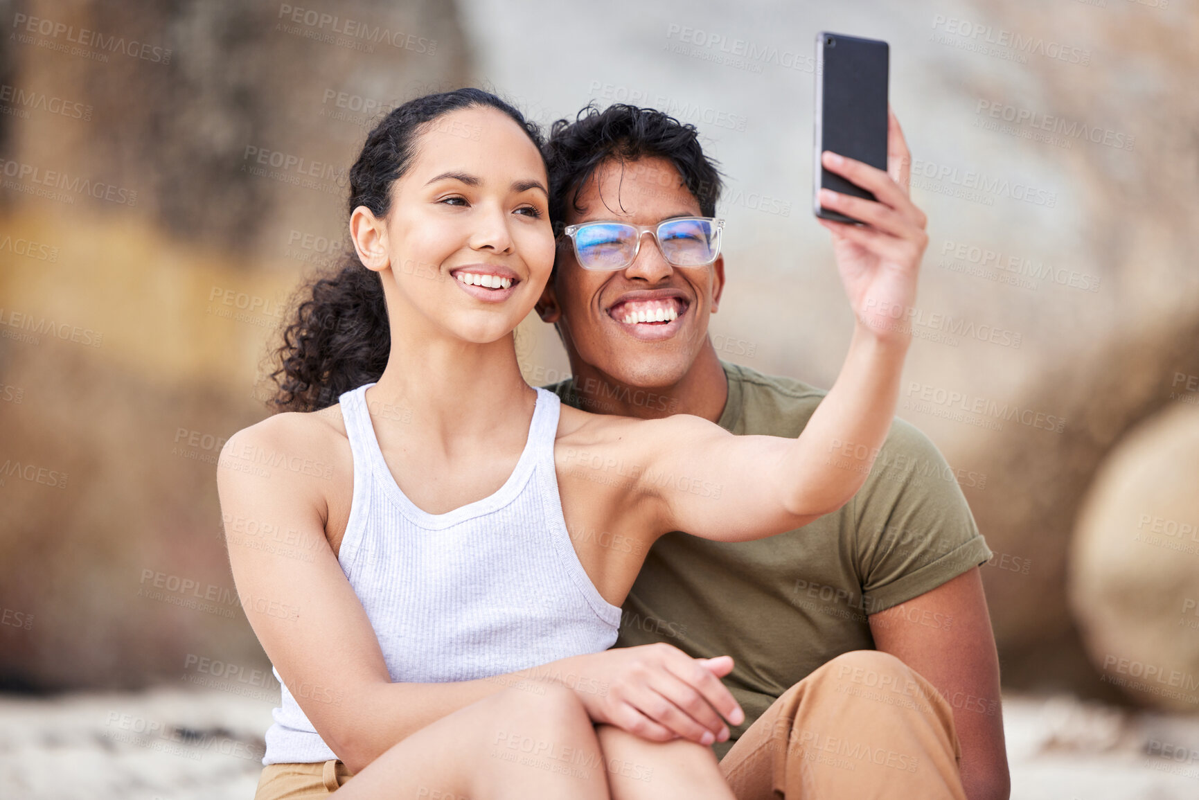 Buy stock photo Shot of a young couple taking a selfie at the beach