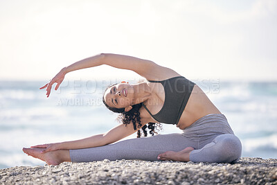 Buy stock photo Shot of a young woman practising yoga on the beach