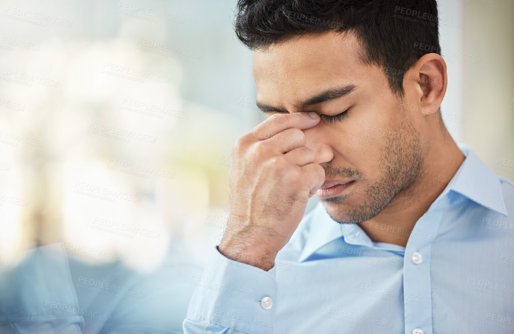 Buy stock photo Shot of a businessman experiencing a headache at work