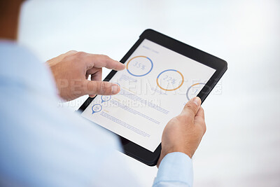 Buy stock photo Shot of a businessman using his digital tablet