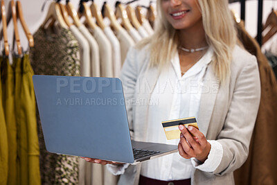 Buy stock photo Shot of a business owner using her laptop to make card payments