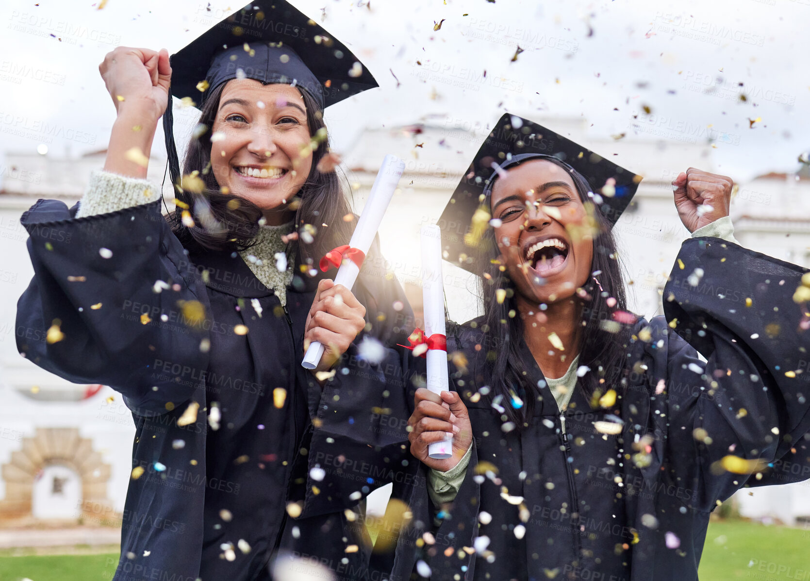 Buy stock photo Cropped portrait of two attractive young female students celebrating on graduation day