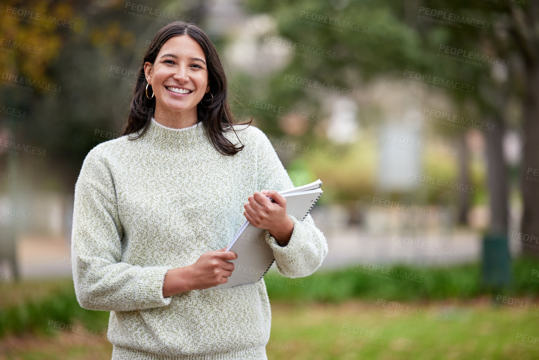 Buy stock photo Portrait of a young woman carrying her schoolbooks outside at college