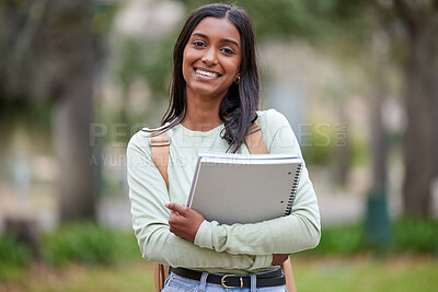 Buy stock photo Portrait of a young woman carrying her schoolbooks outside at college