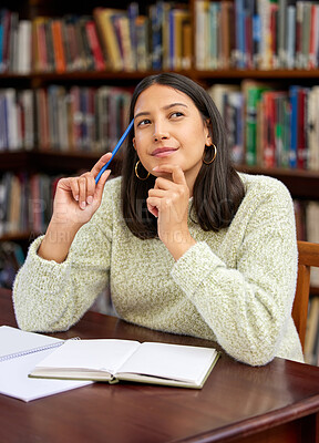 Buy stock photo Shot of a young woman studying in a college library