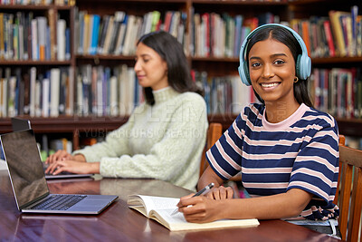 Buy stock photo Shot of two students studying in a library