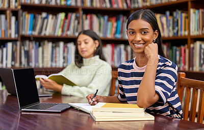 Buy stock photo Shot of two student studying in a library
