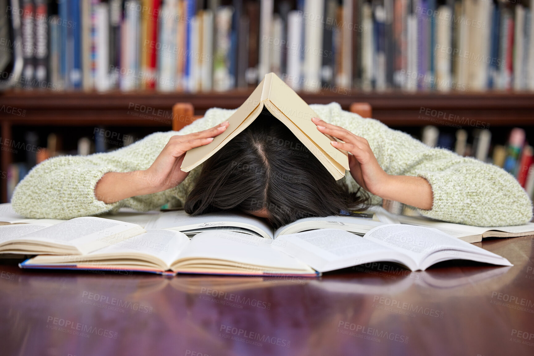 Buy stock photo Student, sleeping and library with woman, headache and course research burnout from brain fog. University, nap and tired from learning, education and studying with deadline and fatigue on campus