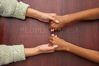 Buy stock photo Support, empathy and people holding hands at school for trust, love and respect. Together, sorry and above of friends or students with a helping hand, forgiveness or compassion at a desk in college