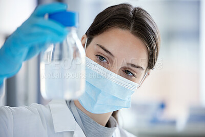 Buy stock photo Shot of a young woman analysing a sample in a lab
