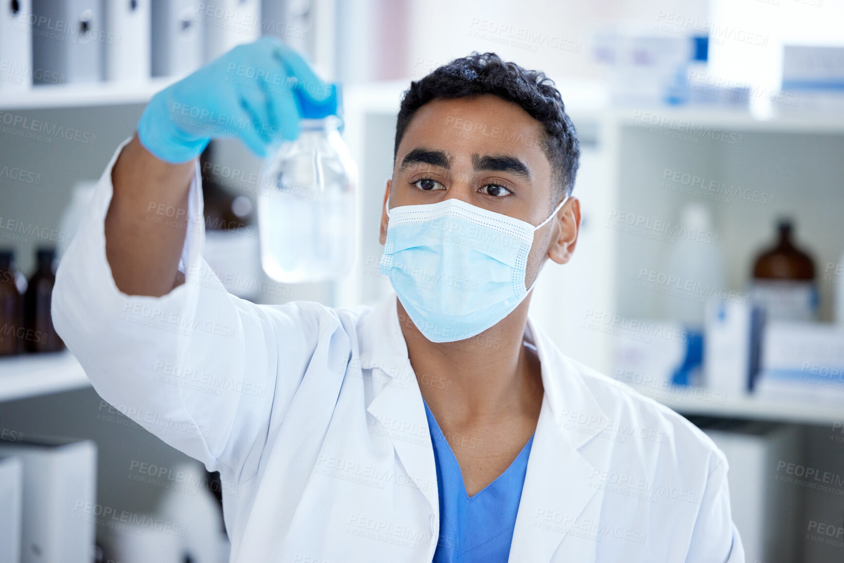 Buy stock photo Science, glass and man with mask, liquid in container and medical research in laboratory. Vaccine innovation, scientist or lab technician with solution, bottle or pharmaceutical development with ppe