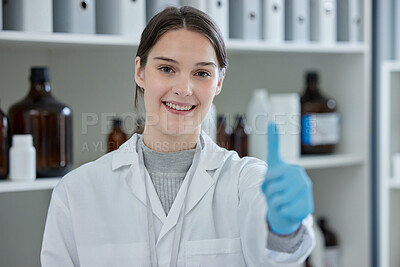 Buy stock photo Portrait of a young scientist showing thumbs up in a lab