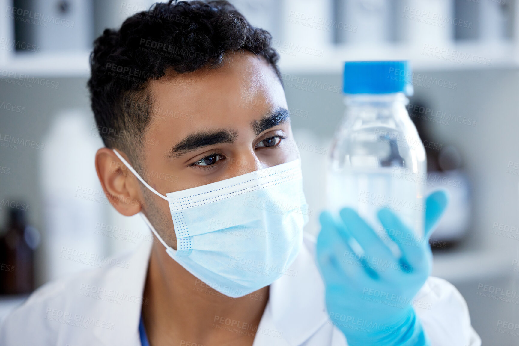 Buy stock photo Science, bottle and man with mask, solution in container and medical research in laboratory. Vaccine innovation, scientist or lab technician with liquid, glass or pharmaceutical development with ppe