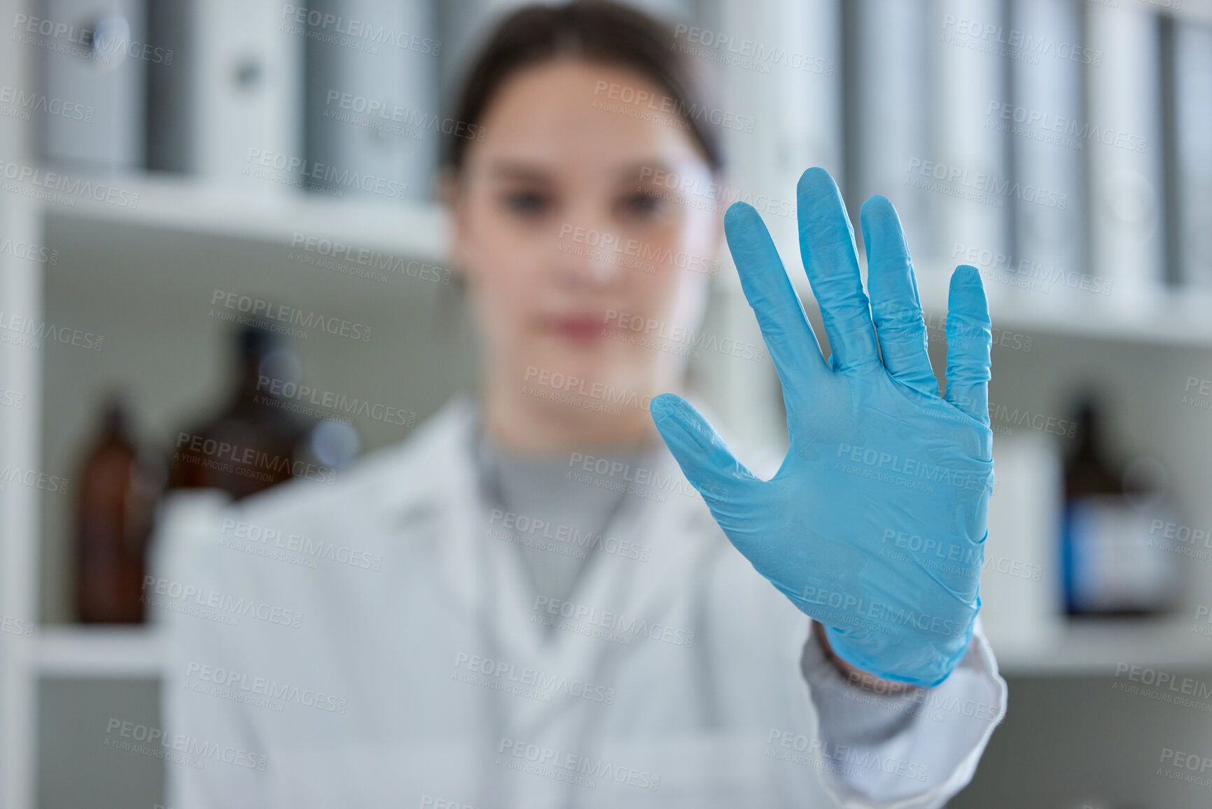 Buy stock photo Closeup shot of a scientist gesturing with her hand in a lab