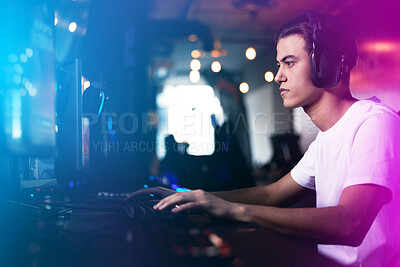 Buy stock photo Man, headphones and computer with gamer in neon lights, esports and online competition in streaming arcade for fun. Serious, tournament and tech for communication, player and virtual video game 