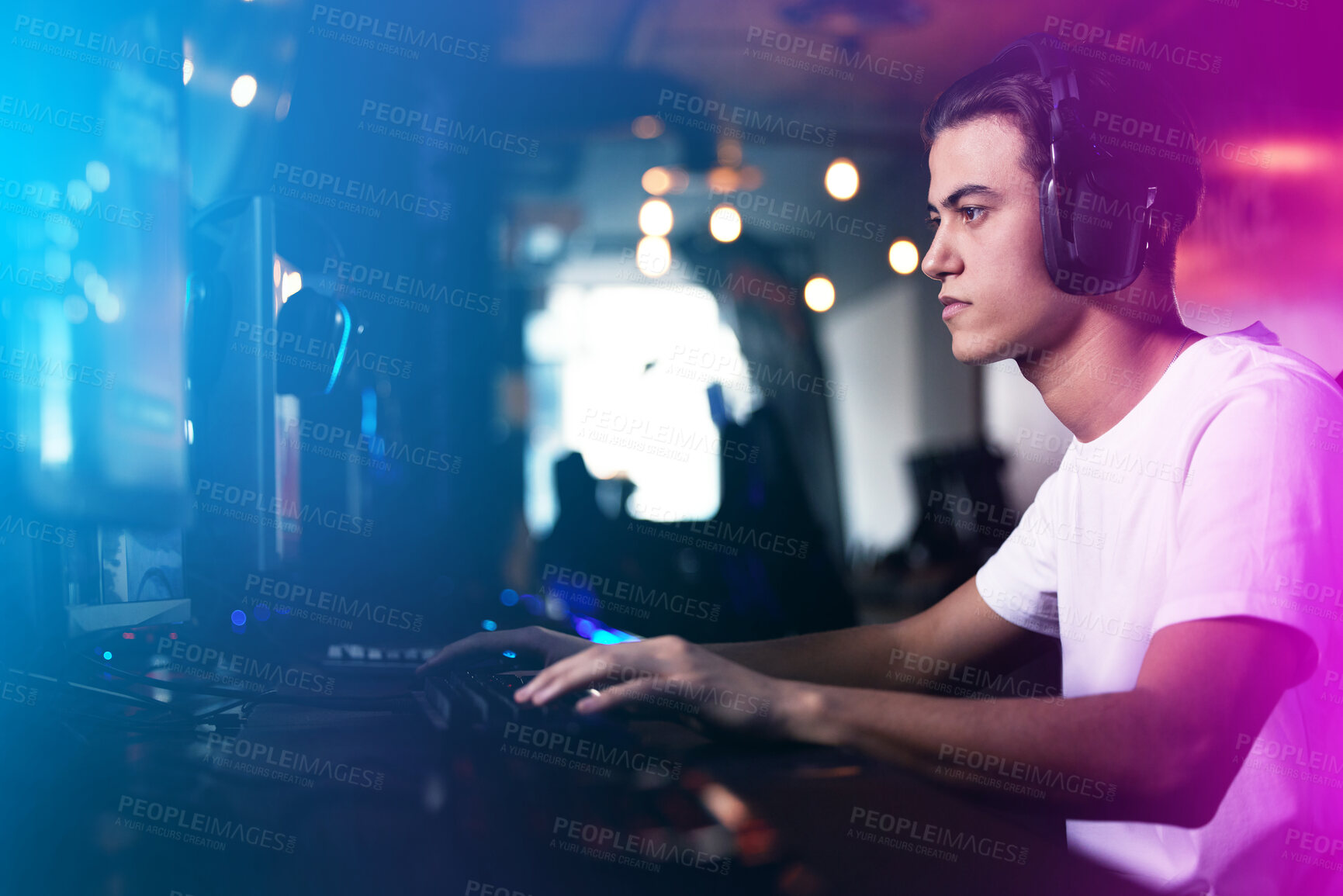 Buy stock photo Man, headphones and computer with gamer in neon lights, esports and online competition in streaming arcade for fun. Serious, tournament and tech for communication, player and virtual video game 