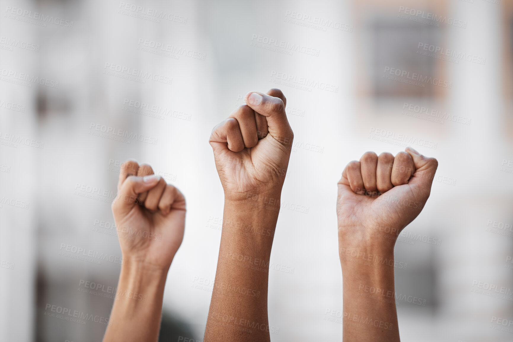 Buy stock photo Shot of an unrecognisable group of women raising her hand in strength outside