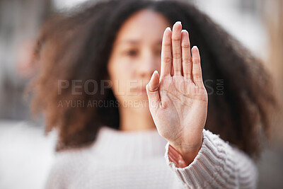 Buy stock photo Shot of an unrecognizable woman making the stop sign with her hand outside