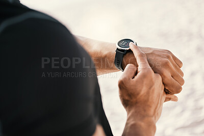 Buy stock photo Cropped shot of an unrecognizable man checking his watch while out for a workout