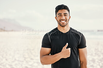 Buy stock photo Shot of a sporty young man showing thumbs up while out for a workout