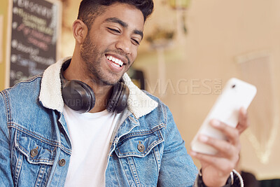 Buy stock photo Smartphone, relax and man in cafe for social media, communication or networking. Online, happiness and male person with headphones for browsing internet, trending update or lunch break in coffee shop