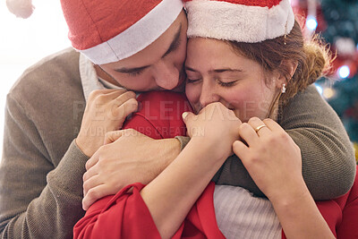 Buy stock photo Christmas, hug and couple with love in home for relationship, bonding and romance in living room. Celebration, marriage and happy man and woman embrace for festive event, holiday and vacation