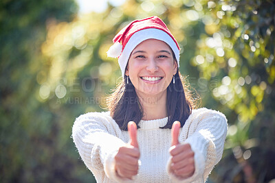 Buy stock photo Woman, thumbs up and happy for Christmas in portrait with Santa hat for festive celebration in garden. Girl, person and smile with sign, symbol and icon for yes, like or agreement for xmas cheers