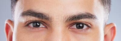 Buy stock photo Shot of an handsome young man’s eyes against a studio background