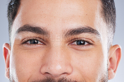 Buy stock photo Happy man, portrait and eyes with natural skin for grooming, eyebrows or masculine beauty on a gray studio background. Closeup of handsome male person or young model staring with iris, gaze or pupil