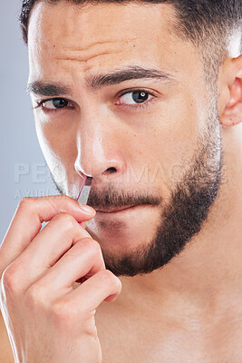 Buy stock photo Beauty, portrait and man with tweezers in studio for nose hair removal and grooming routine on grey background. Face, self care and Mexican male model with pride, nasal or cleaning tools for wellness
