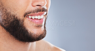 Buy stock photo Cropped studio shot of an unrecognisable man smiling against a grey background