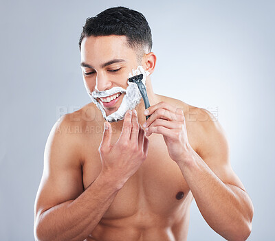 Buy stock photo Skincare, foam and happy man shaving face in studio for wellness, hygiene and cosmetic treatment on grey background. Cleaning, beauty and Mexican model with facial, hair removal and razor blade 