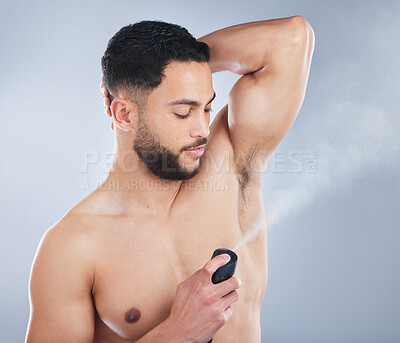 Buy stock photo Man, deodorant and spray in studio for hygiene, fragrance and stop sweat for fresh scent by background. Model, person and liquid with perfume, aroma and clean armpit with healthy grooming routine