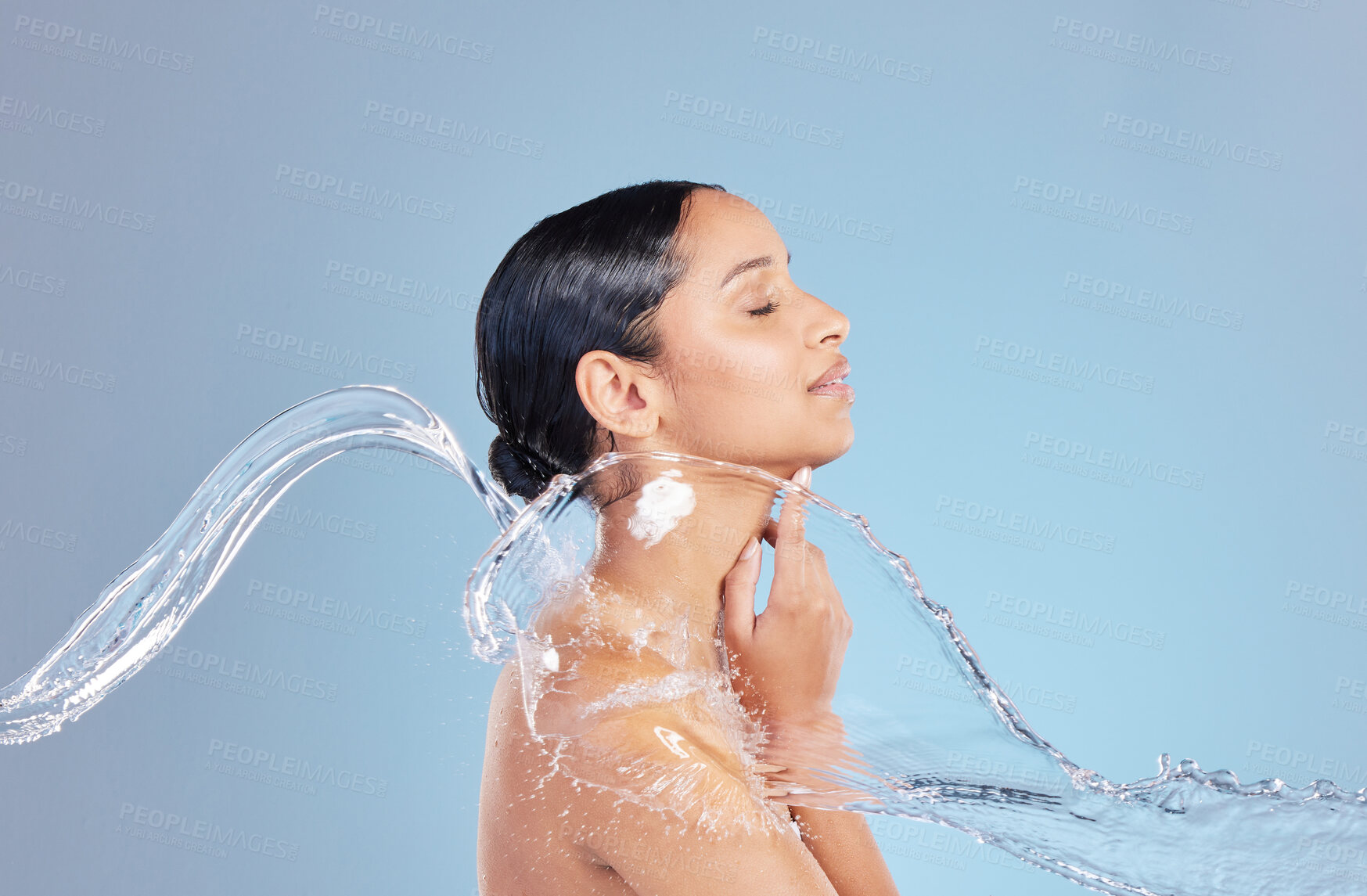 Buy stock photo Woman, water splash and shower with cleaning in studio for hygiene, bacteria and dirt by blue background, Girl, person and model for hydration, profile and stop germs for healthy body for skincare